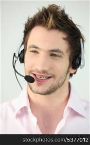 Attractive man speaking into a headset