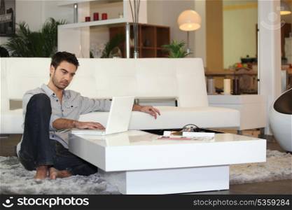Attractive man using a laptop