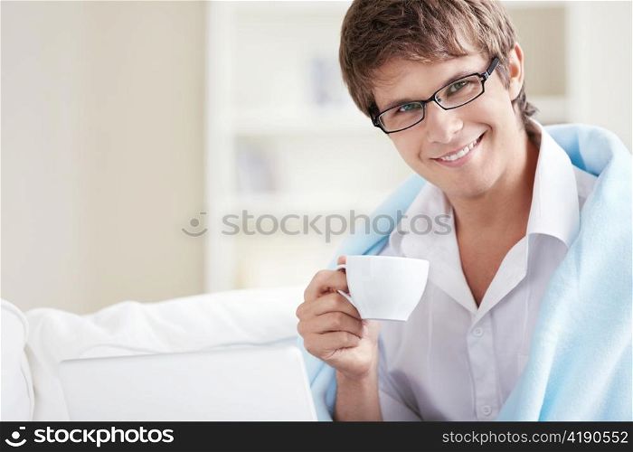 Attractive man with a cup in his hand