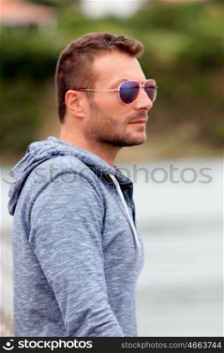 Attractive man with sunglasses looking at something