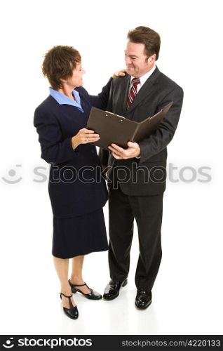 Attractive mature business man and woman going over a report. Full body isolated on white.
