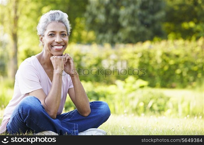 Attractive Mature Woman Sitting In Garden