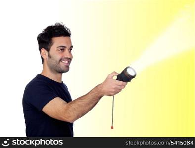 Attractive men in black with a flashlight looking for something on yellow background