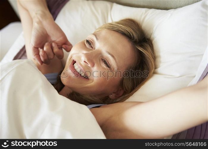 Attractive Middle Aged Woman Waking Up In Bed