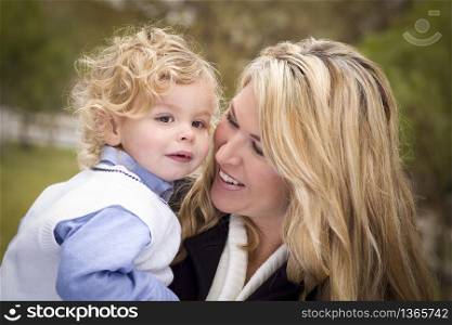 Attractive Mother and Cute Son Portrait Outside at the Park.