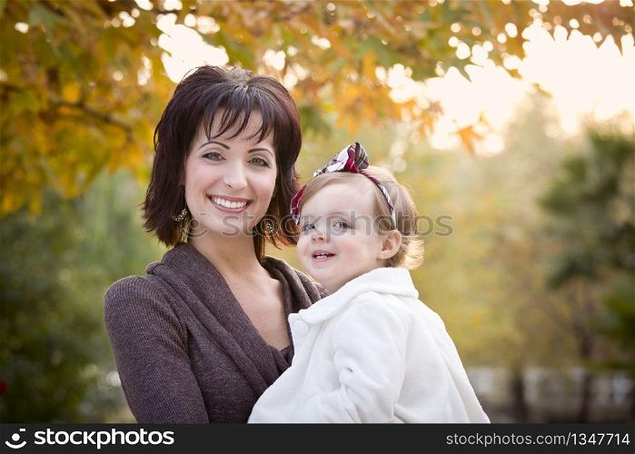 Attractive Mother and Daughter Portrait Outside at the Park.