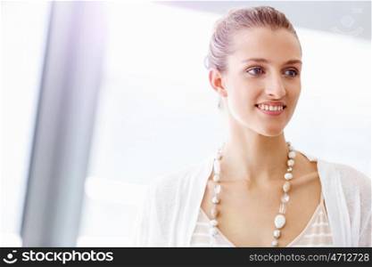 Attractive office worker portrait. Attractive woman in white in office