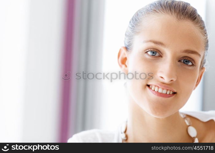 Attractive office worker sitting at desk. Attractive woman sitting at desk in office