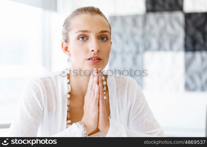 Attractive office worker sitting at desk. Attractive woman sitting at desk in office