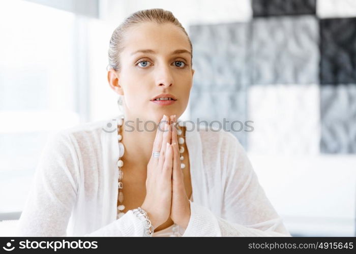 Attractive office worker sitting at desk. Attractive woman sitting at desk in office