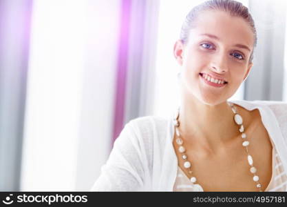 Attractive office worker sitting at desk. Attractive woman sitting at desk in office