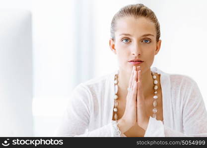 Attractive office worker sitting at desk. Attractive woman sitting at desk in office