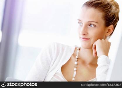 Attractive office worker sitting at desk. Attractive woman sitting at desk in office portrait