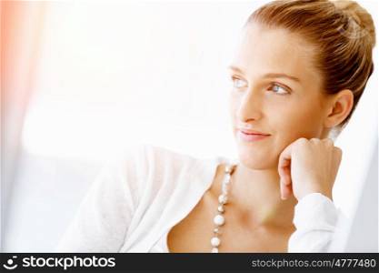 Attractive office worker sitting at desk. Attractive woman sitting at desk in office portrait
