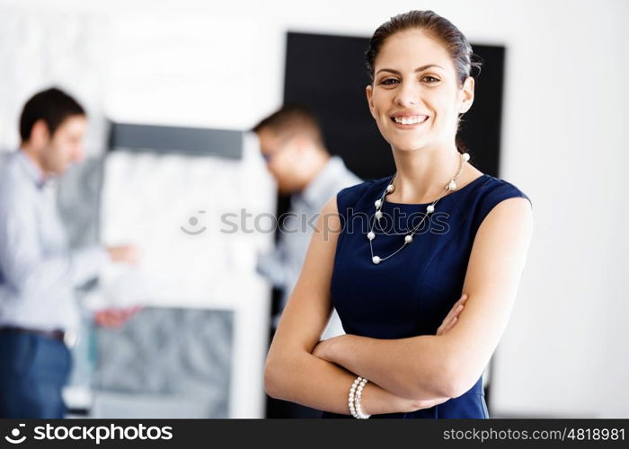 Attractive office worker standing. Attractive woman standing in office