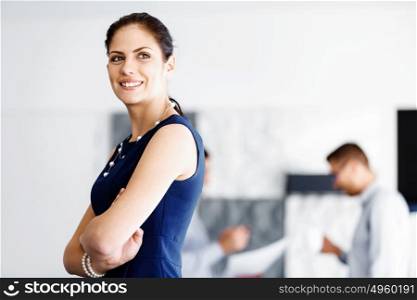 Attractive office worker standing. Attractive woman standing in office