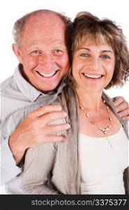 Attractive old couple posing as man hugs his wife from behind, isolated on white background.