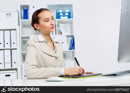 Attractive photo editor working on computer in a modern office. Designer at work