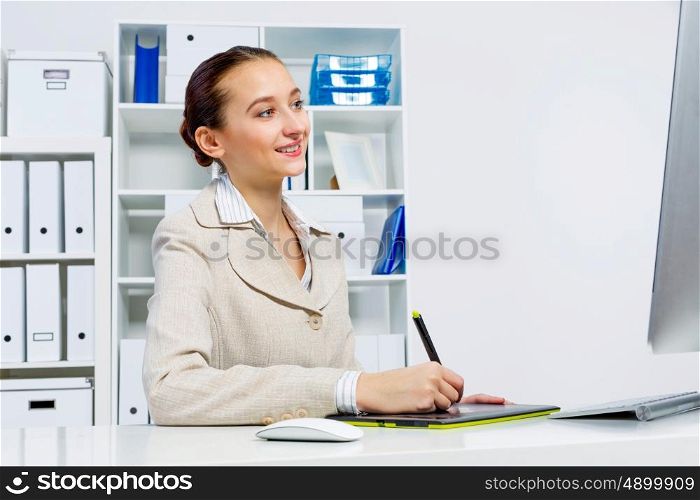 Attractive photo editor working on computer in a modern office. Designer at work