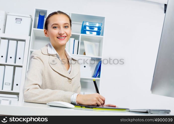 Attractive photo editor working on computer in a modern office. Designer at work