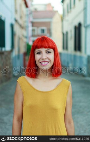 Attractive red hair girl with yellow dress in the street