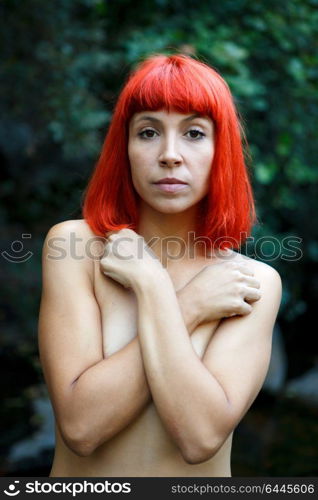 Attractive red hair girl without clothes in the nature.