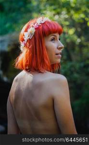 Attractive red hair girl without clothes in the nature.
