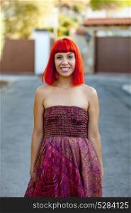 Attractive red hair woman with a beautiful dress in the street