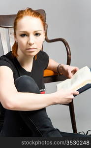 attractive red-haired girl with books