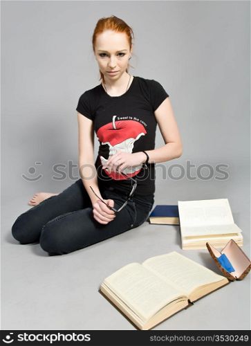attractive red-haired girl with books