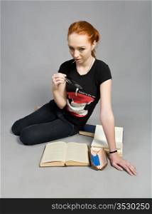 attractive red-haired girl with books