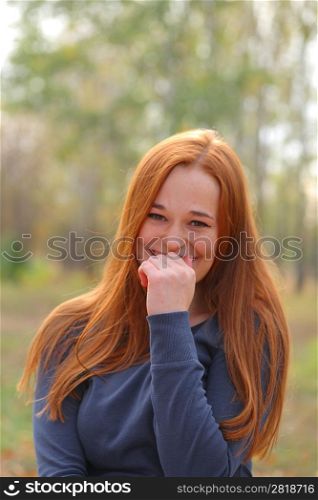 Attractive redhead in autumn having fun