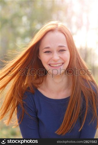 Attractive redhead in autumn having fun