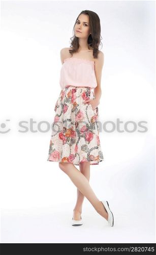 Attractive sensual woman in pink dress on white background