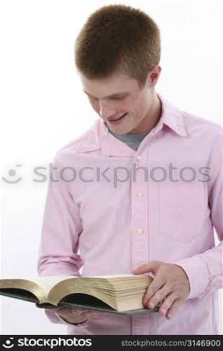 Attractive seventeen year old boy with open book.