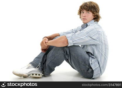 Attractive Sixteen Year Old Teen Boy In Casual Clothes Over White. Light brown curly hair and hazel eyes.