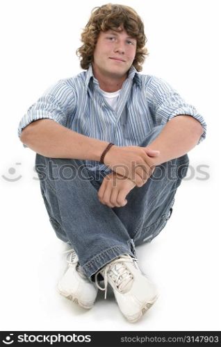 Attractive Sixteen Year Old Teen Boy in casual over white background. Light brown curly hair and hazel eyes.