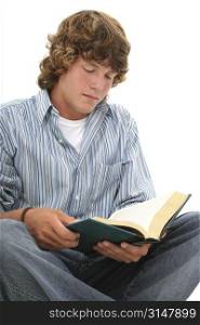 Attractive sixteen year old teen sitting on floor reading book.