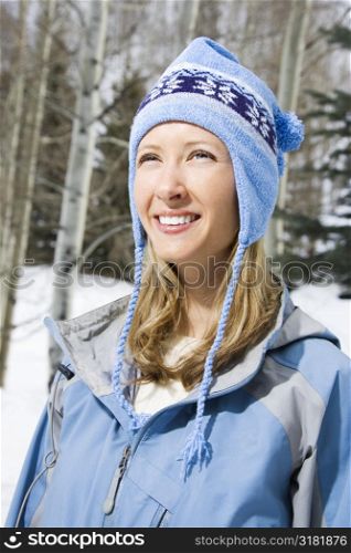 Attractive smiling mid adult Caucasian blond woman wearing blue ski clothing.