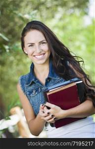 Attractive Smiling Mixed Race Young Girl Student with School Books Outdoors.