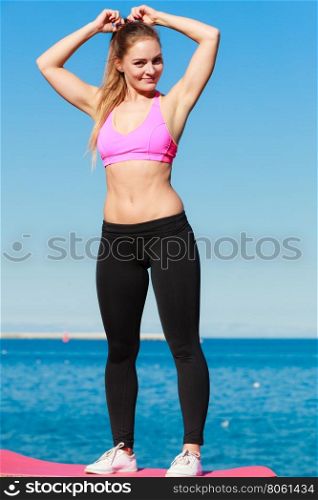 Attractive sporty girl outdoor. Beauty sporty slim girl training outdoor. Young attractive happy girl posing in sports clothing.