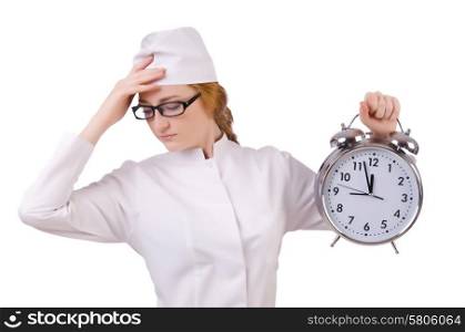 Attractive stressed woman doctor with big clock isolated on white