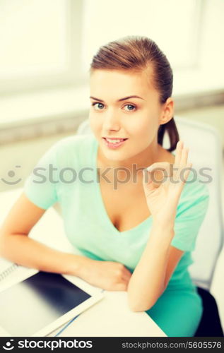 attractive student girl with tablet pc showing ok gesture