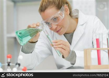 attractive student of chemistry working in laboratory