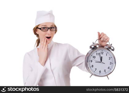 Attractive surprised woman doctor with big clock isolated on white