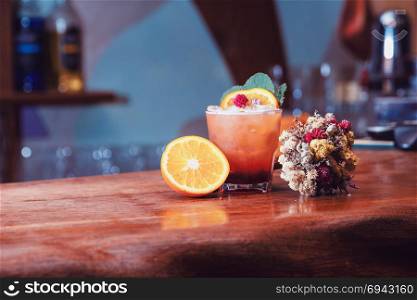 attractive tasty drink, with a bouquet of dried flowers, mint and orange. still life.