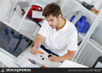 attractive technician calculating quote at clients home