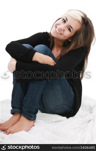 attractive teenage girl sits twining arms about legs