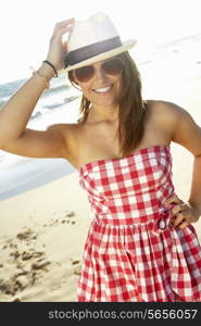 Attractive Teenage Girl Wearing Dress On Beach Holiday