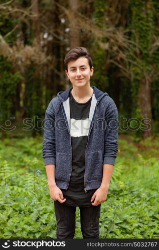 Attractive teenager guy in a park with green plants of background